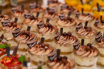 Small glasses filled with traditional Tiramisu at a wedding buffet