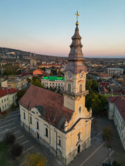 Obraz premium European bell tower with old red roof town in the background, Vršac, Serbia - aerial drone photo