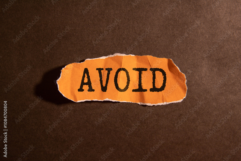 Poster the text avoid is written on wooden blocks on a light background.