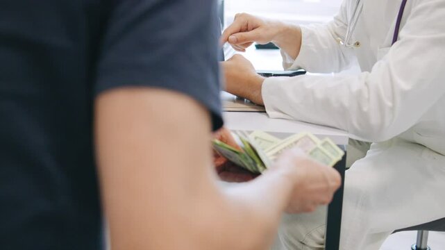 A patient discreetly offers a bribe to a doctor during a consultation, highlighting a moment of ethical conflict in a professional medical setting.