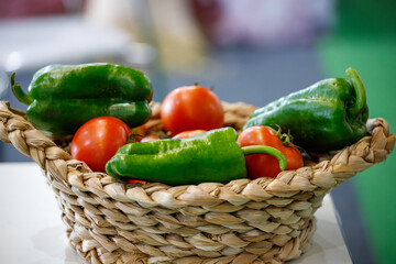 basket of vegetables with peppers and tomatoes on a table in Rio de Janeiro.