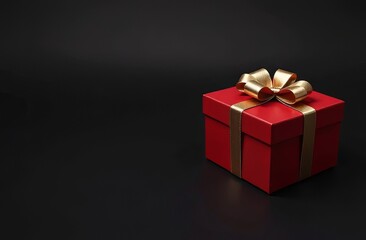 Obraz premium This striking red gift box features an elegant gold ribbon and bow, set against a solid black background that highlights its vibrant color and festive appeal, perfect for celebrations. Copy space