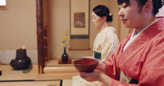 Woman, drinking and Japanese herbal tea in cup at traditional ceremony or event for prayer in Japan. Female person, cultural clothes and heritage with teapot for matcha beverage, herbs and flavor