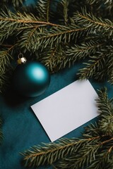 Christmas ball nestled on a pine branch with a blank greeting card, perfect for holiday wishes