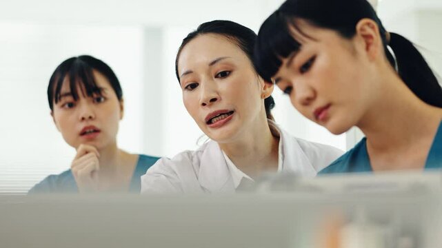 Japanese, hospital and women training with advice, communication and doctor with meeting and notes. Nurse, employee and discussion with icu clinic procedure and questions with healthcare management