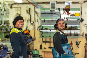 A marine engineers stands in the engine room workshop. The scene captures a moment of preparation, as the officers readies for hands-on work.