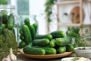 Fresh cucumbers, dill and spices on table, closeup. Preparation for pickling