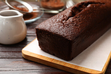 Tasty chocolate sponge cake on wooden table, closeup