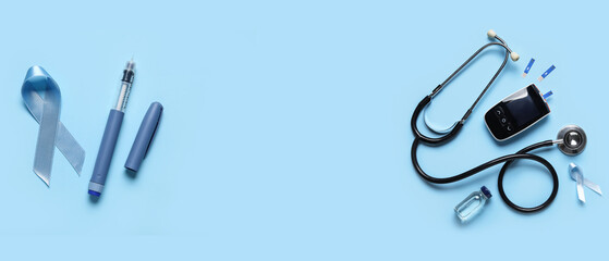 Awareness ribbon with glucometer, insulin and stethoscope on blue background. Diabetes concept