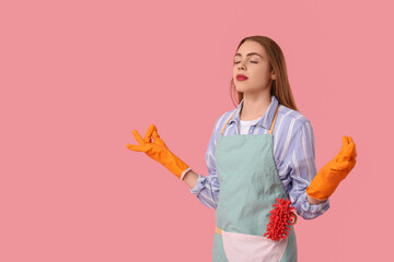 Beautiful young housewife meditating on pink background. Zen concept