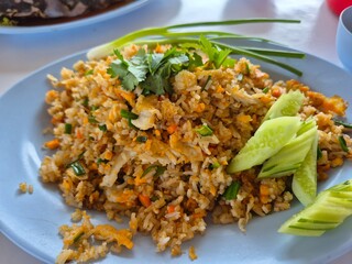 Traditional fried rice mixed with chicken egg, crab meat and mince pork serving on the plate. Famous seafood menu in Asian restaurant. 