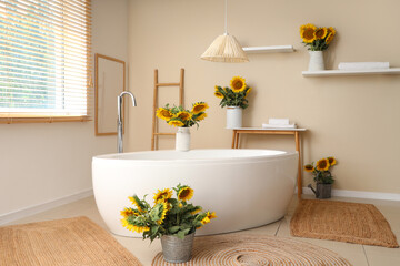 Bouquets of sunflowers in interior of bathroom