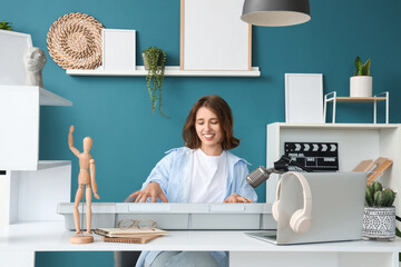 Young woman with synthesizer recording podcast in studio