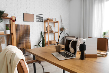 Podcaster's workplace with laptop and microphone in studio