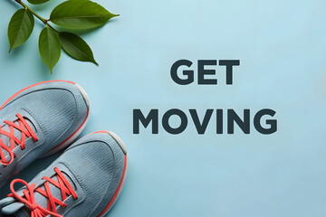 Motivational message "Get Moving" with sport shoes and green leaves on light blue background