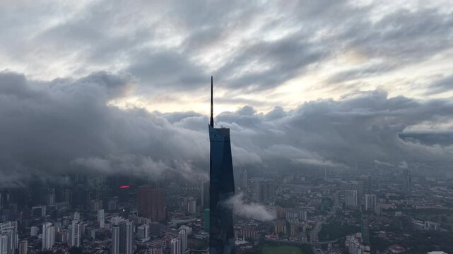 dramatic sunrise with low cloud above Kuala Lumpur city center visible sky scraper tower above the cloud