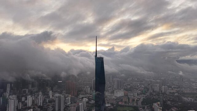 dramatic sunrise with low cloud above Kuala Lumpur city center visible sky scraper tower above the cloud