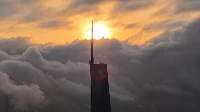 dramatic sunrise with low cloud above Kuala Lumpur city center visible sky scraper tower above the cloud