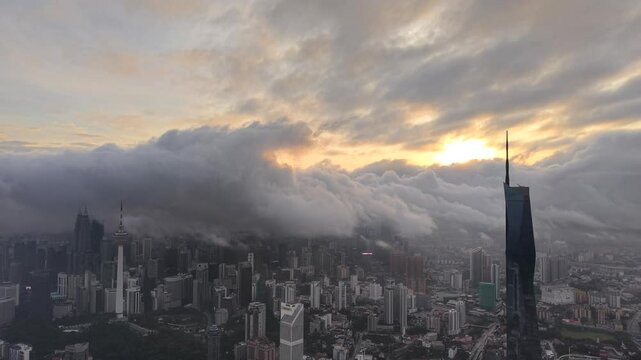 dramatic sunrise with low cloud above Kuala Lumpur city center visible sky scraper tower above the cloud