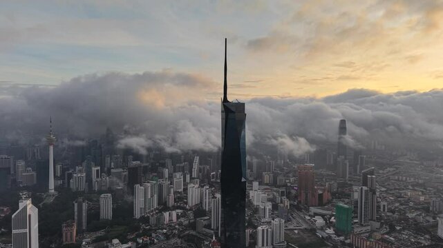 dramatic sunrise with low cloud above Kuala Lumpur city center visible sky scraper tower above the cloud