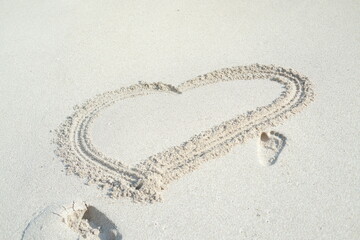 Heart drawn on the beach sand