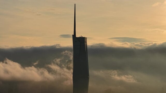 dramatic sunrise with low cloud above Kuala Lumpur city center visible sky scraper tower above the cloud