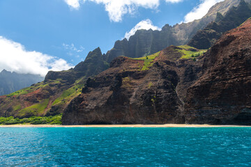 The iconic cliffs of the Na Pali Coast rise steeply from the ocean, creating a stunning contrast of...