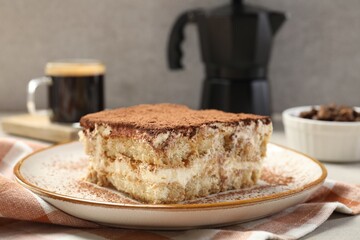 Piece of tasty tiramisu on table, closeup