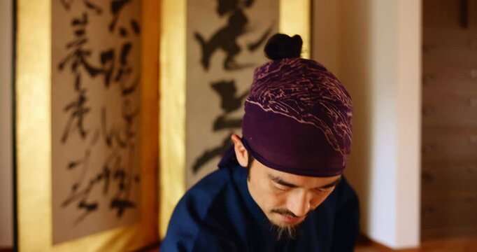 Prayer, sword and martial arts sensei in dojo for practice routine, bushido and spirituality. Respect, Japanese man and virtues for fighting, tradition and samurai culture for warrior discipline