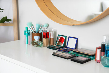 Decorative cosmetics on table in makeup room, closeup