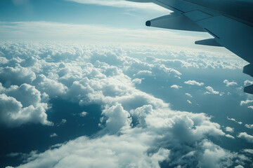 Fototapeta premium Aerial view of clouds from an airplane window, showcasing the vast sky and atmosphere.