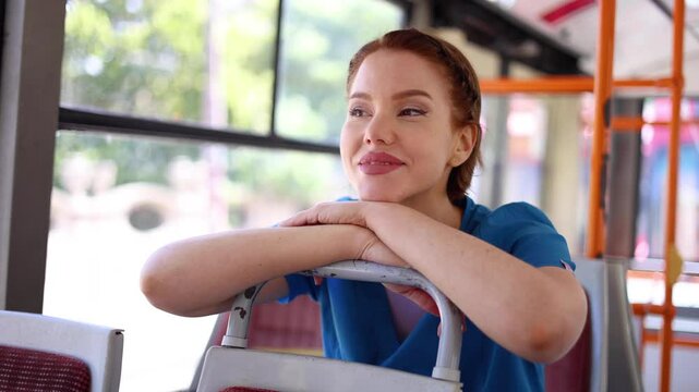 Beautiful nurse riding in a city bus