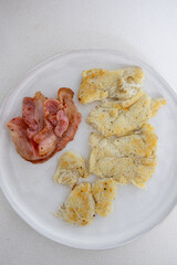 A plate of bacon and potato hash.