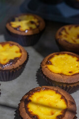 the irresistible allure of freshly baked egg tarts, their golden, flaky crusts perfectly crisp and their creamy custard filling gleaming under the light.
