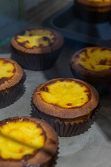 the irresistible allure of freshly baked egg tarts, their golden, flaky crusts perfectly crisp and their creamy custard filling gleaming under the light.