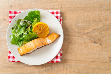 fried salmon steak with lemon and vegetable