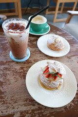 choux cream or cream puff, eclair or strawberry choux cream  , iced cocoa and coffee