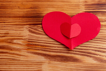 Valentine's day celebration concept, two red hearts on a light board