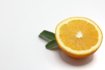 slice of navel orange with green leaves on isolated background