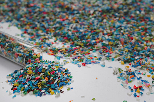 Hands hold clear white plastic pellets, raw materials for various manufacturing processes. These pellets are widely used in industries to produce products like packaging, bottles, and equipment parts.