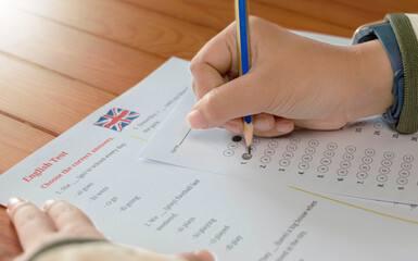 English test and bubble answer sheet on table in class