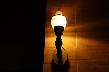 A floor lamp hanging on the floor. Evening ambiance and light. Exterior and urban design or outdoor architecture.
