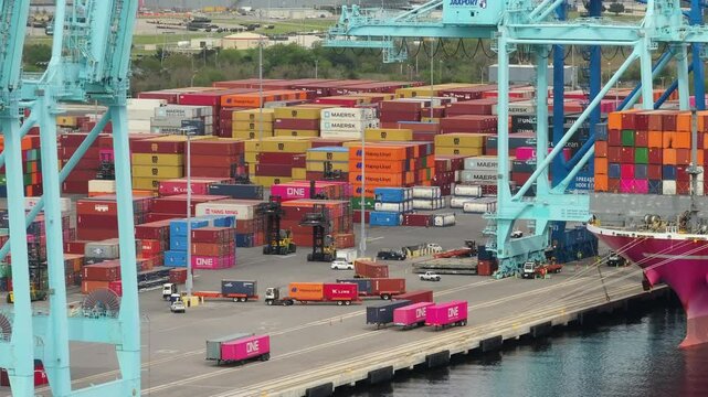 Freight containers for international shipment of produced goods. Unloading container ship in port of Savannah, Georgia.