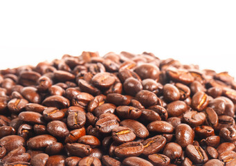 Close up of a collection of roasted coffee beans, isolated on a white background with copy space. for background illustrations and pattern designs.