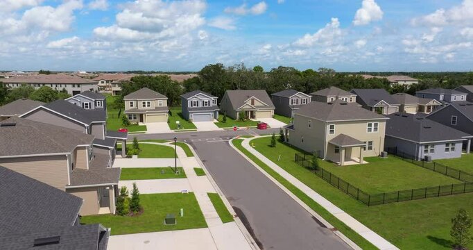 Gated community with expensive houses between green palm trees in southwest Florida. Premium housing development in the USA