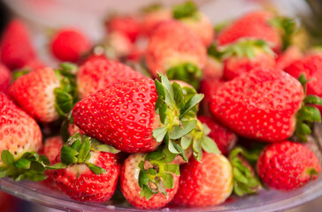 Fresh, ripe red strawberries in a glass bowl, close-up view. Caipirinha