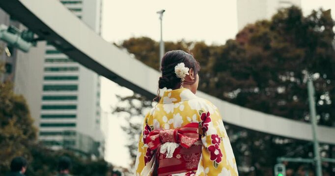 Back, Japanese woman and walk for travel in traditional clothes, outfit or fashion as model in city. Female person, heritage and creative in kimono as style, culture and dress for tourism or history