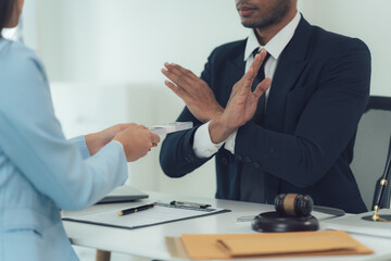 Refusal of Bribery:  A lawyer firmly rejects a bribe offered by a client, emphasizing the...