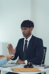 Refusing the Deal: A lawyer in a formal suit sits at a desk and extends his hand in a firm gesture...