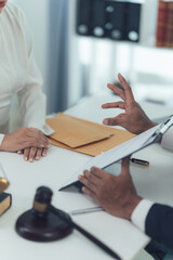 Legal Consultation:  A lawyer gestures emphatically as he explains legal documents to a client, signifying trust and expertise.